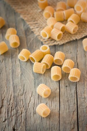 Dry pasta on wooden backgroundの写真素材