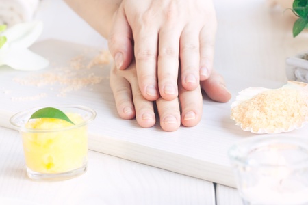 Spa manicure  setting with beauty products and female handsの写真素材