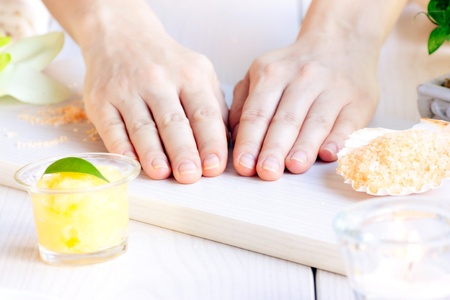 Spa manicure  setting with beauty products and female handsの写真素材