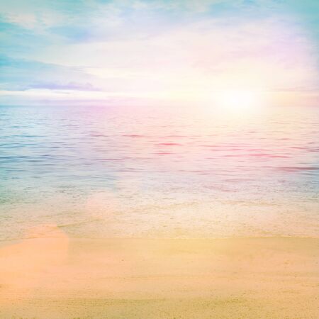 Summer or spring abstract background. Golden sand with blue ocean and cloudscape and sunset in the back.の写真素材