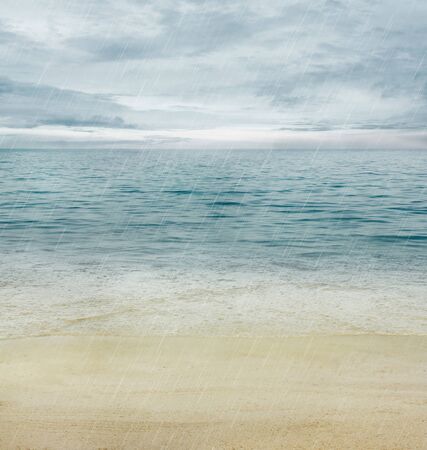Summer or spring abstract background. Golden sand with blue ocean and cloudscape and sunset in the back.の写真素材