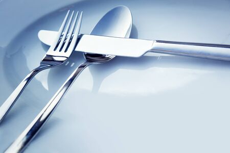 Restaurant menu series  Wedding or dinner table place setting  Fork and knife and glass in elegant setting with copyspaceの写真素材