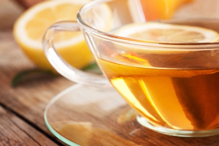 Cup of organic  lemon fruit tea on nature wooden backgroundの写真素材