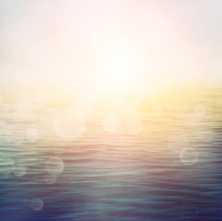 Abstract nature summer or spring ocean sea background  Small waves on water surface in motion blur with bokeh lights from sunrise