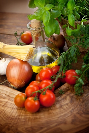 Fresh ingredients for italian cuisine  pasta, tomatoes, basil, olive oil, garlic and onionの写真素材