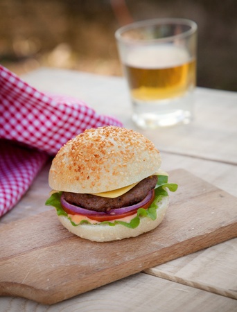 Delicious hamburger in rustic setting  Burger on wooden board with beerの写真素材