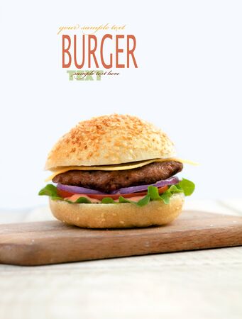 Delicious hamburger isolated on white with copyspace  Burger on wooden boardの写真素材