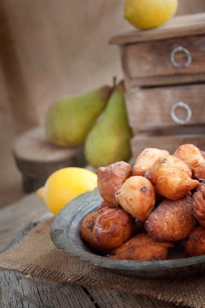 Bowl of Deep fried fritters donuts in rustic country settingの写真素材