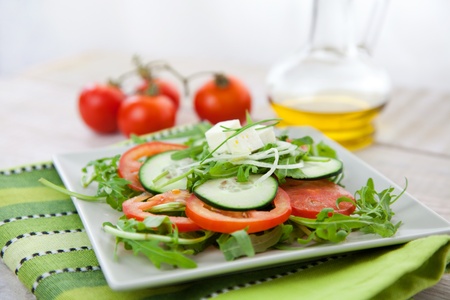 Healthy vegetable salad with lettuce, feta cheese, rocket salad, tomatoesの写真素材