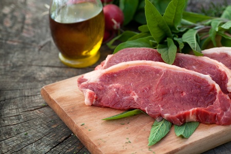 Raw meat with fresh vegetables and rosemaryの写真素材
