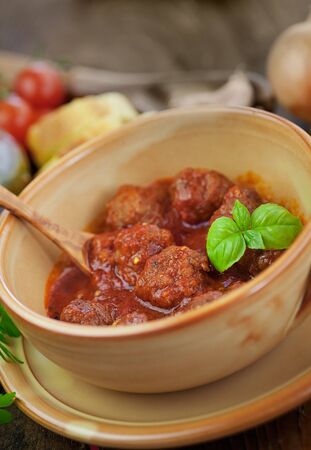 Italian cooking  - meat balls with basil, tomatoes, olive oil and garlicの写真素材
