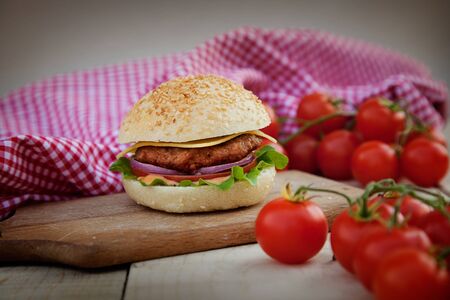 Delicious hamburger in rustic setting  Burger on wooden board with beerの写真素材
