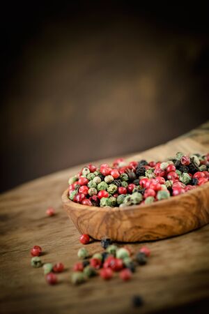 Dry pepper variety. Red,green and black pepper on wooden backgroundの写真素材