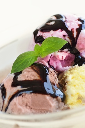 Chocolate, strawberry and vanilla Ice cream with chocolate syrupの写真素材