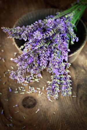 Fresh lavender over wooden background. Summer floral background with lavender flowers and wood.の写真素材