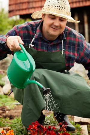 Spring garden concept. Male is doing garden work in herb gardenの写真素材