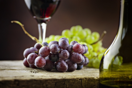 Wine concept. Food and drink background with red wine, fresh grapes and wine bottleの写真素材