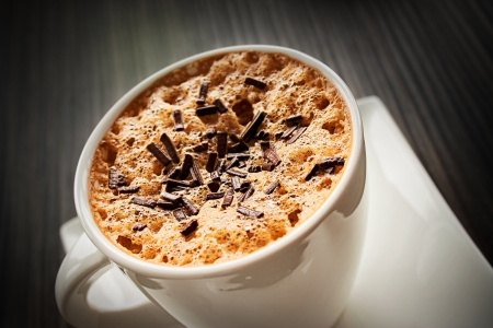 Coffee Cappuccino in white cup with chocolate sprinklesの写真素材
