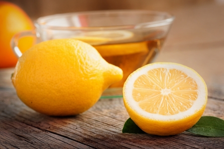 Hot drink. Cup of organic  lemon fruit tea on nature wooden backgroundの写真素材