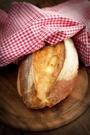 Freshly baked bread on wooden backgroundの写真素材