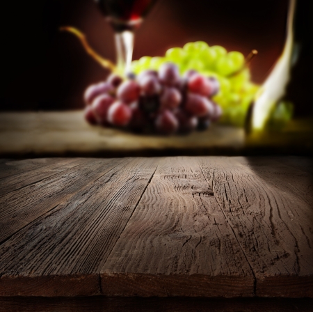 Wine concept. Food and drink background with red wine, fresh grapes and wine bottleの写真素材