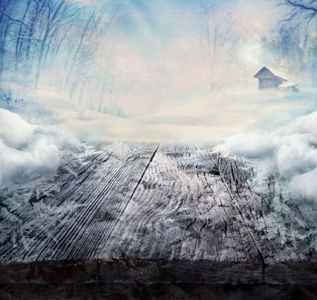 Winter design - Christmas background with Frozen wooden table with landscape  Snow and ice on wooden table with snowy forest with cabin in the background の写真素材