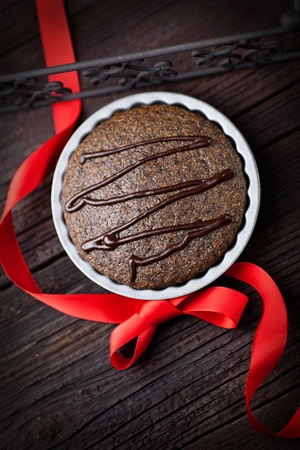 Chocolate cake  Souffle with red ribbon on wood の写真素材