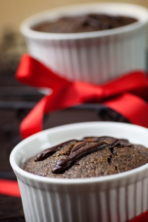 Chocolate cake. Souffle with red ribbot on wood.の写真素材