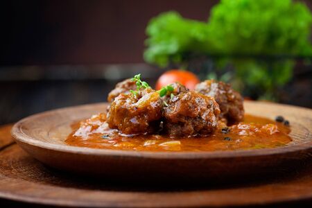 Italian cooking with beef meat balls with cherry tomatoes, tomato sauce and basilの写真素材