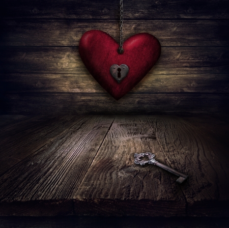Valentines design - Locked Heart in chains. Love concept Illustration with heart hanging on chains with keyhole and vintahe key on wooden background.の写真素材