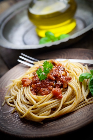 Italian food  Pasta spaghtti with tomato sauce, olives and garnishの写真素材
