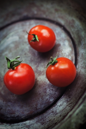 Cherry tomatoes  Vintage vegetables background with tomatoes in grunge styleの写真素材