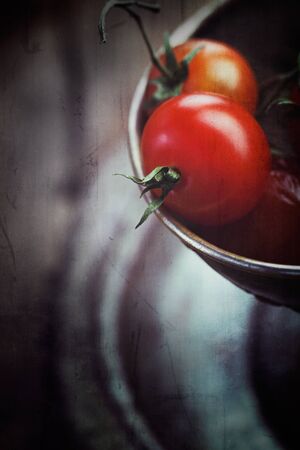 Cherry tomatoes  Vintage vegetables background with tomatoes in grunge styleの写真素材