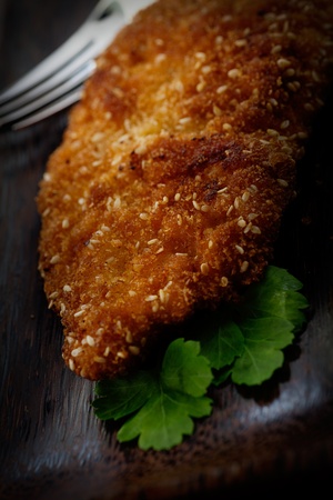 Fried panned chicken with sesame seeds and herbsの写真素材