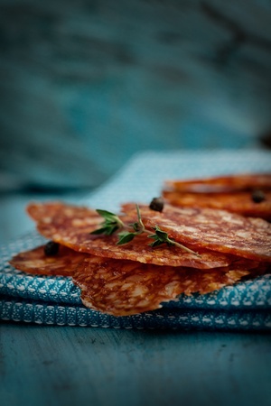 chorizo salami sausage on blue rustic background. Meat cold cuts.