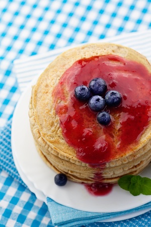 Breakfast food. Pancakes with jam and blueberries.の写真素材