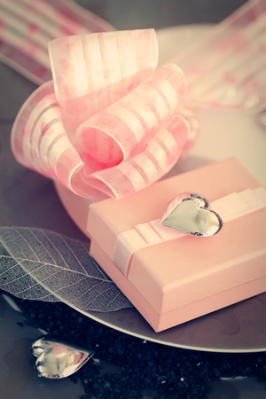 Restaurant series  Valentines day dinner with table setting in pink and gray and holiday elegant heart ornamentsの写真素材