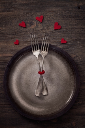 Valentines day dinner with table setting in rustic wood style with cutleryの写真素材