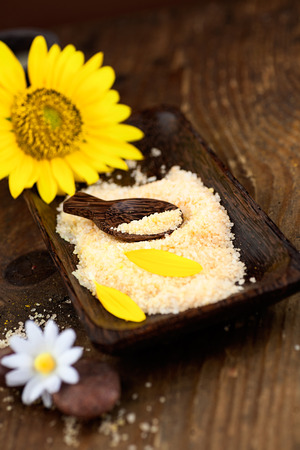 Spa and wellness setting with natural bath salt, candles and towel, massager and sunflower.. Brown dayspa nature set with copyspaceの写真素材