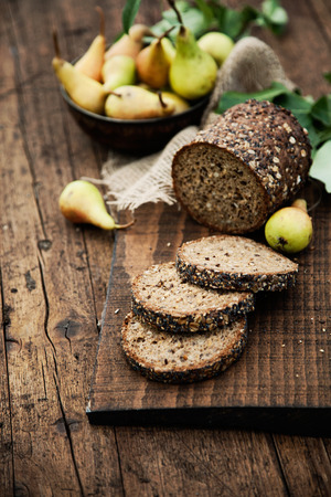Fresh healthy bread on wood. Breakfast with bread and fruitの写真素材