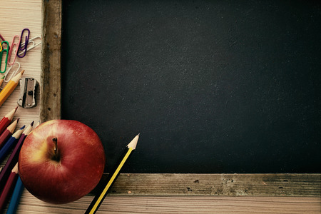 School objects for students. Chalkboard, pencils, crayons and appleの写真素材