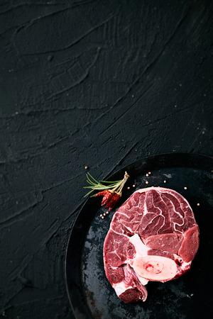 Meat. Raw meat steak black with herbsの写真素材