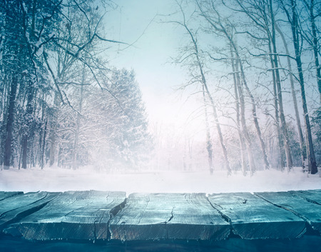 Winter snow landscape with wooden table in front.の写真素材