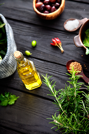 Olive oil with herbs. Mediterranean ingredients: rosemary, olives, thyme, sage, salt, oreganoの写真素材