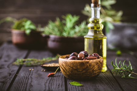 Olive oil with herbs. Mediterranean ingredients: rosemary, olives, thyme, sage, salt, oreganoの写真素材