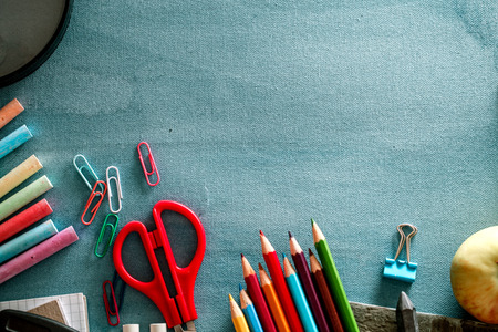 Back to school. School background with supplies. Pencils, chalk and school equipment.