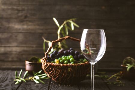 Wine glass with grapes. Fresh grapes on wood. Autumn fruitの写真素材