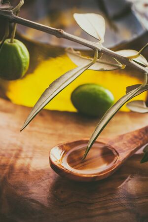 Extra virgin healthy Olive oil with fresh olives on rustic wooden backgroundの写真素材