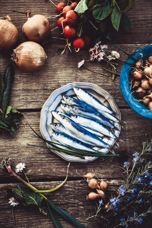 Fresh sardines. Fish with vegetables. Mediterranean fish on plateの写真素材