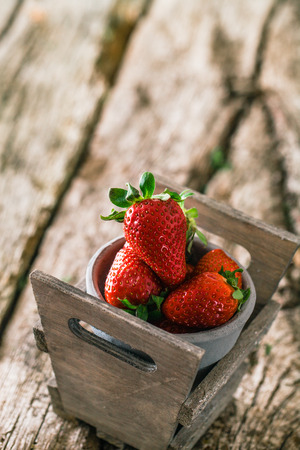 Fresh fruit. Strawberries on wood. Spring fruit.の写真素材